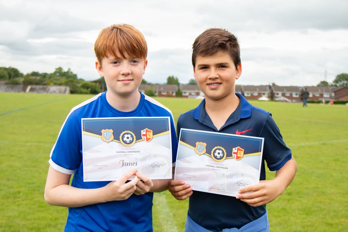 Students receiving football certificates
